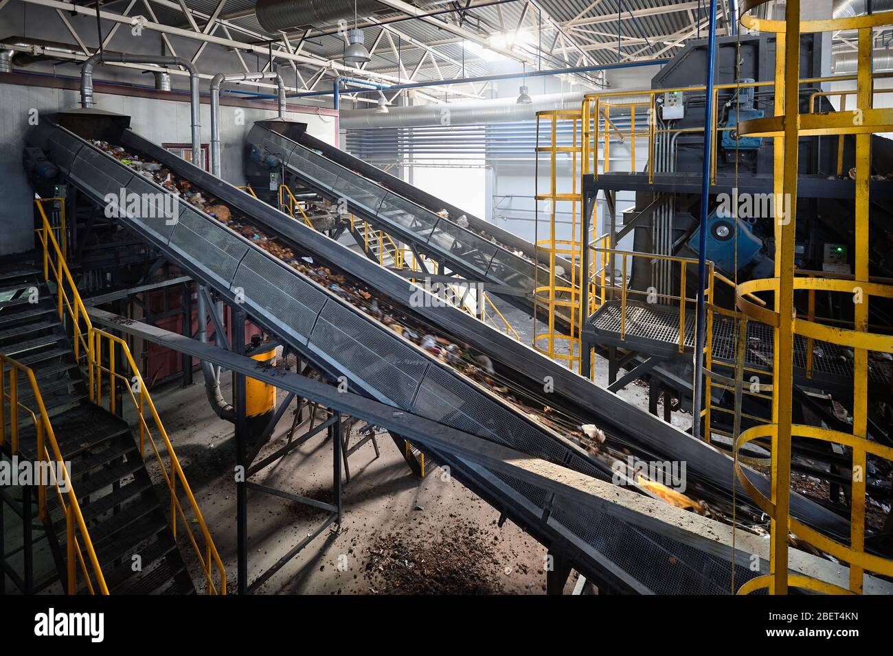 Convoyeur avec déchets dans une usine moderne de recyclage des déchets transportant des déchets du service de réception au service de tri manuel pour un traitement ultérieur Banque D'Images