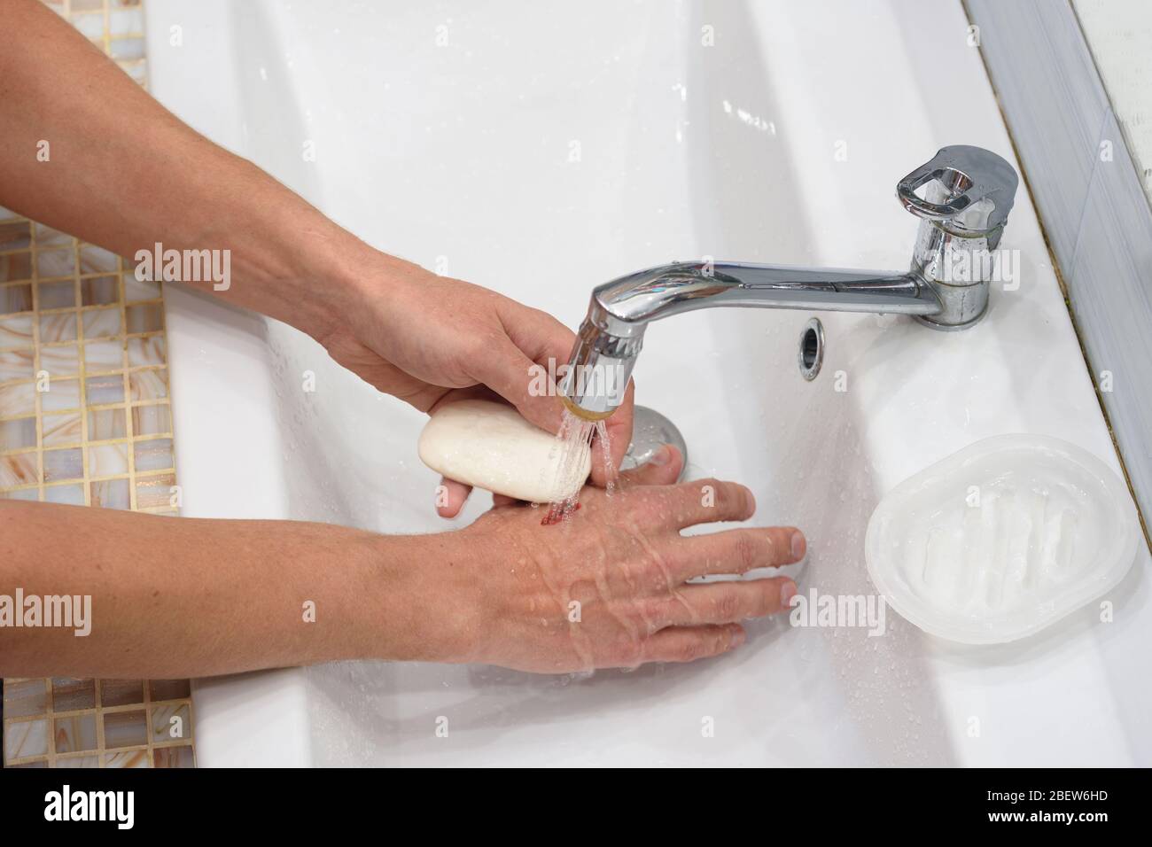 Un homme fournit le premier moyen de couper ses mains, laver la plaie avec  du savon Photo Stock - Alamy