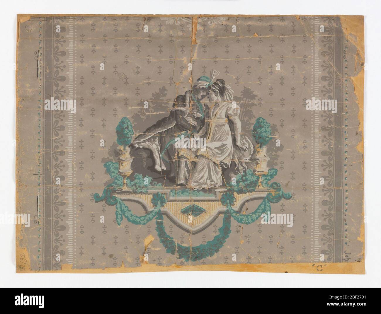 Flanc. Sur un sol gris/taupe, remplissage gris de points en poudre, lignes; bordure verticale grise de fleurs symétriques et stylisées; vignette de femme assise et d'homme en turban. Imprimé en gris, blanc et turquoise. Banque D'Images