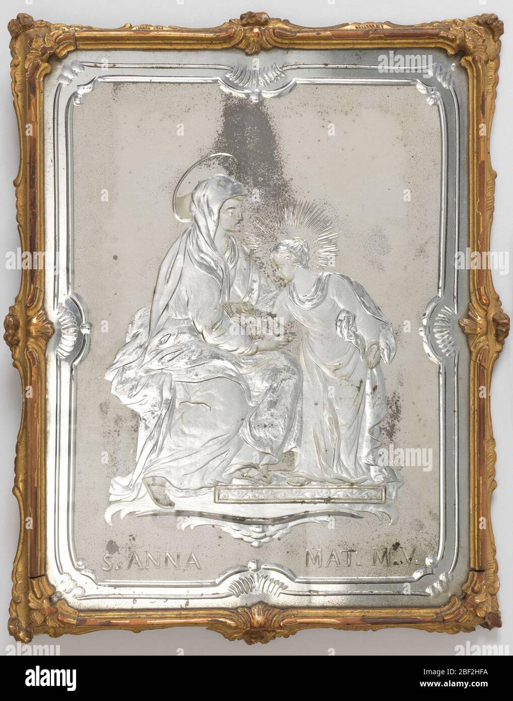 Miroir. Panneau rectangulaire en verre avec bords gravés en forme de terre mate entourant le sujet gravé de la jeune Vierge debout avec la Saint Anne assise sur la légende: 'S. ANNA MAT. M. V.'; dans un cadre étroit de bois doré. Banque D'Images
