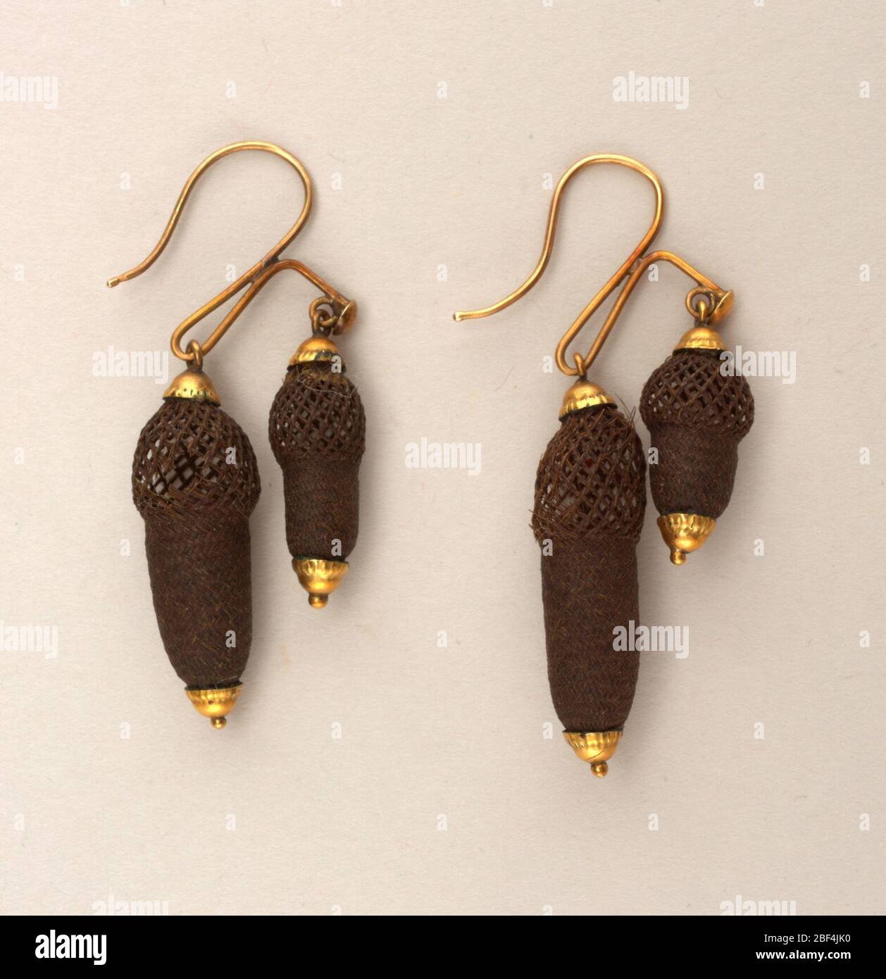 Boucles d'oreilles. Paire de boucles d'oreilles de travail de hairi tissé sous forme sphérique et cylindrique, montées en or. Banque D'Images