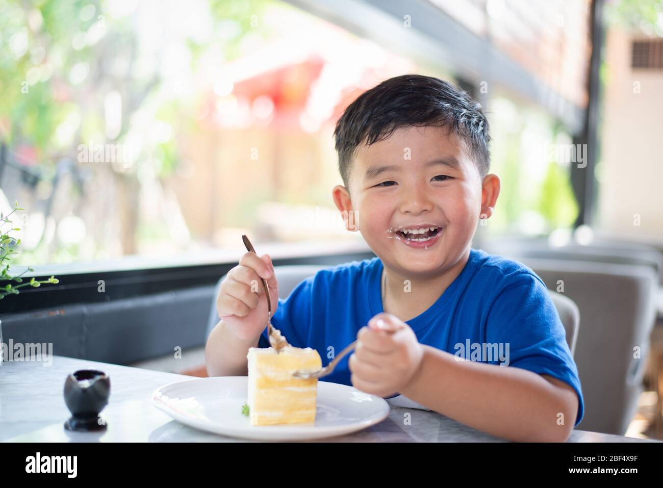 Happy Young Boy And Girl Eating Cake At Birthday Party Stock Photo, Picture  and Royalty Free Image. Image 22168349.
