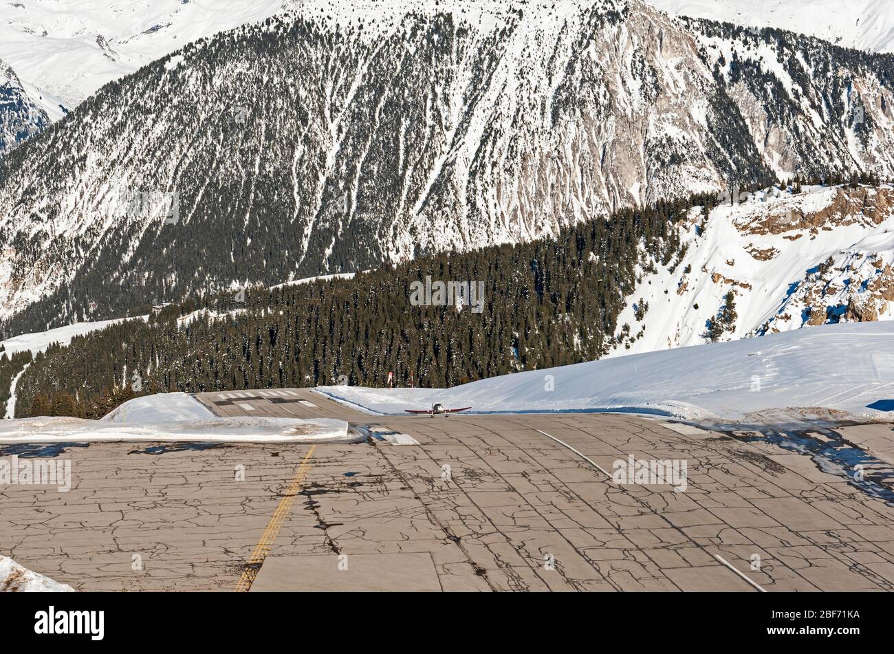 Paysage panoramique vue du petit aéroport de la piste de l'altiport sur le flanc d'une montagne des Alpes couvertes de neige en hiver Banque D'Images