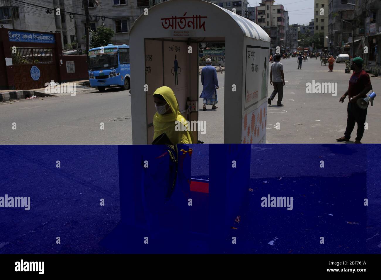 Dhaka, Bangladesh. 17 avril 2020. Les piétons traversent une cabine de vaporisation de désinfectant contre le nouveau coronavirus COVID-19 à Dhaka. Crédit: MD Mehedi Hasan/ZUMA Wire/Alay Live News Banque D'Images