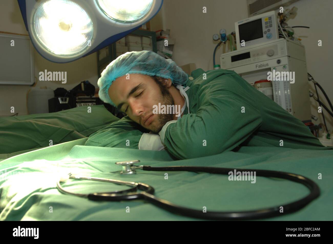 Un jeune chirurgien prend un repos bien mérité. Banque D'Images