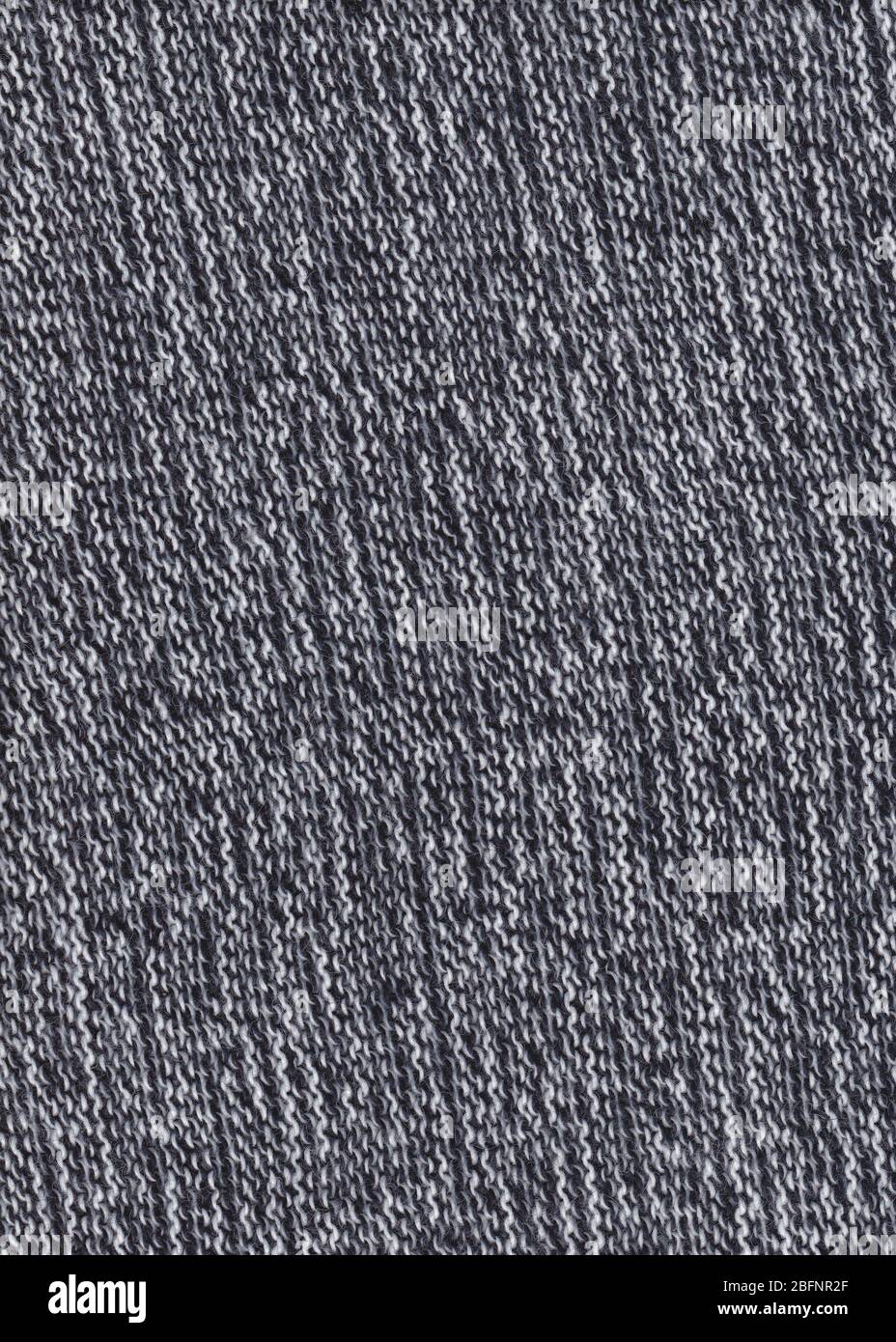 Texture du tissu tricoté. Arrière-plan par temps froid. Texture de pull chaud en laine noire et blanche. Arrière-plan en tissu tricoté. Banque D'Images