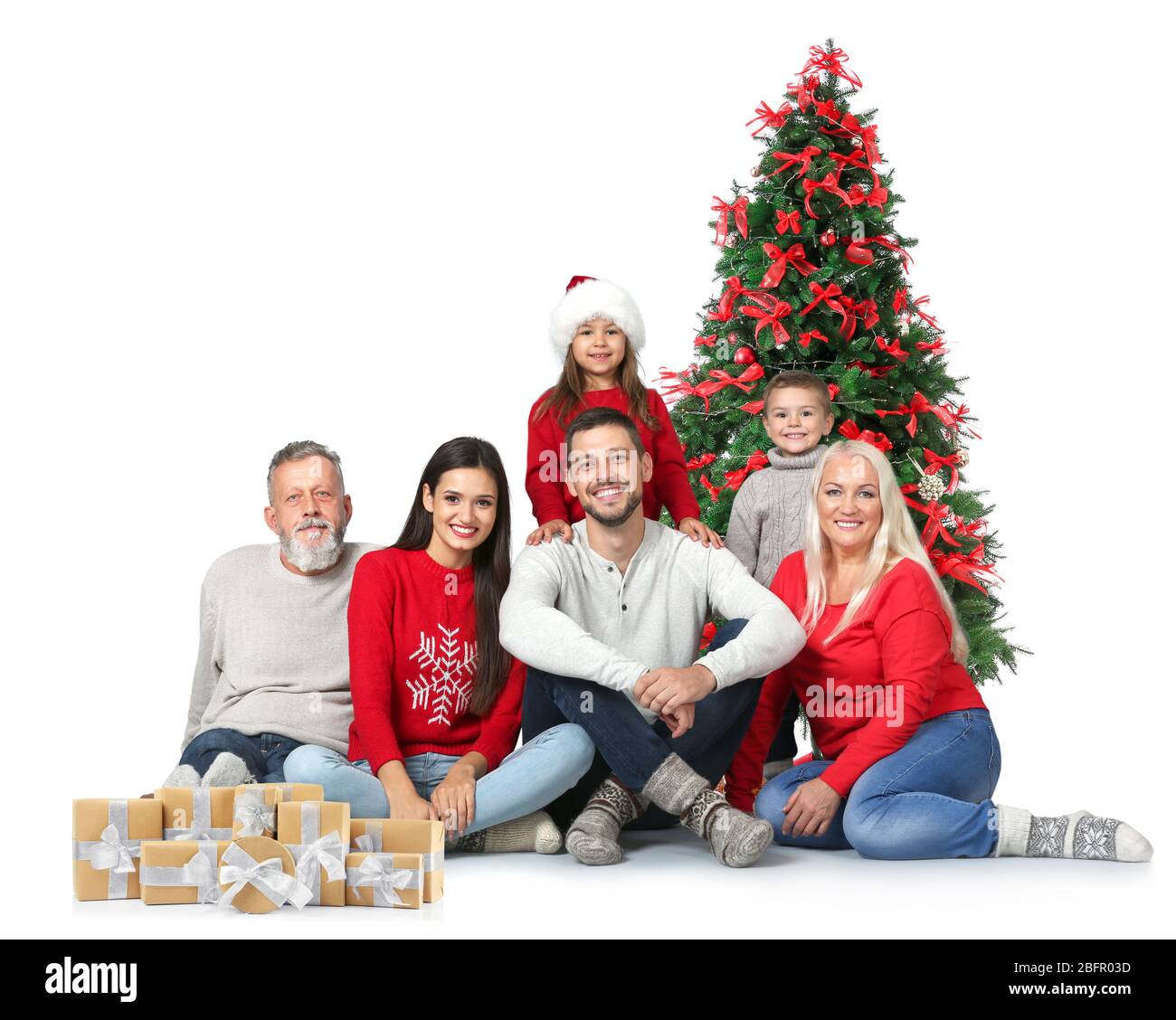 Famille heureuse avec des boîtes cadeaux et arbre de Noël décoré sur fond blanc Banque D'Images