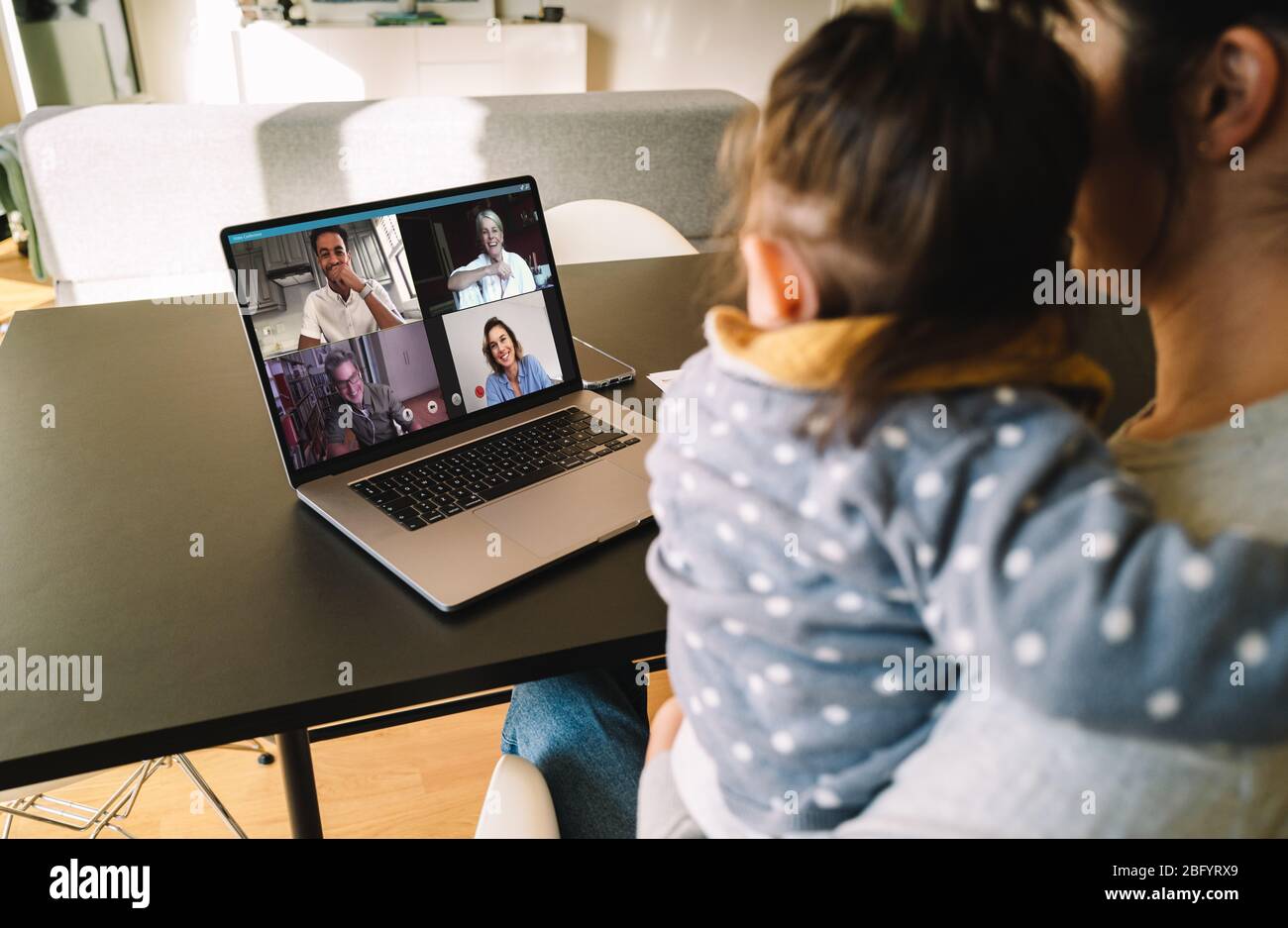 Femme et fille à la maison ayant une conférence vidéo avec sa famille et ses amis. Femme parlant avec ses amis sur Internet. Banque D'Images
