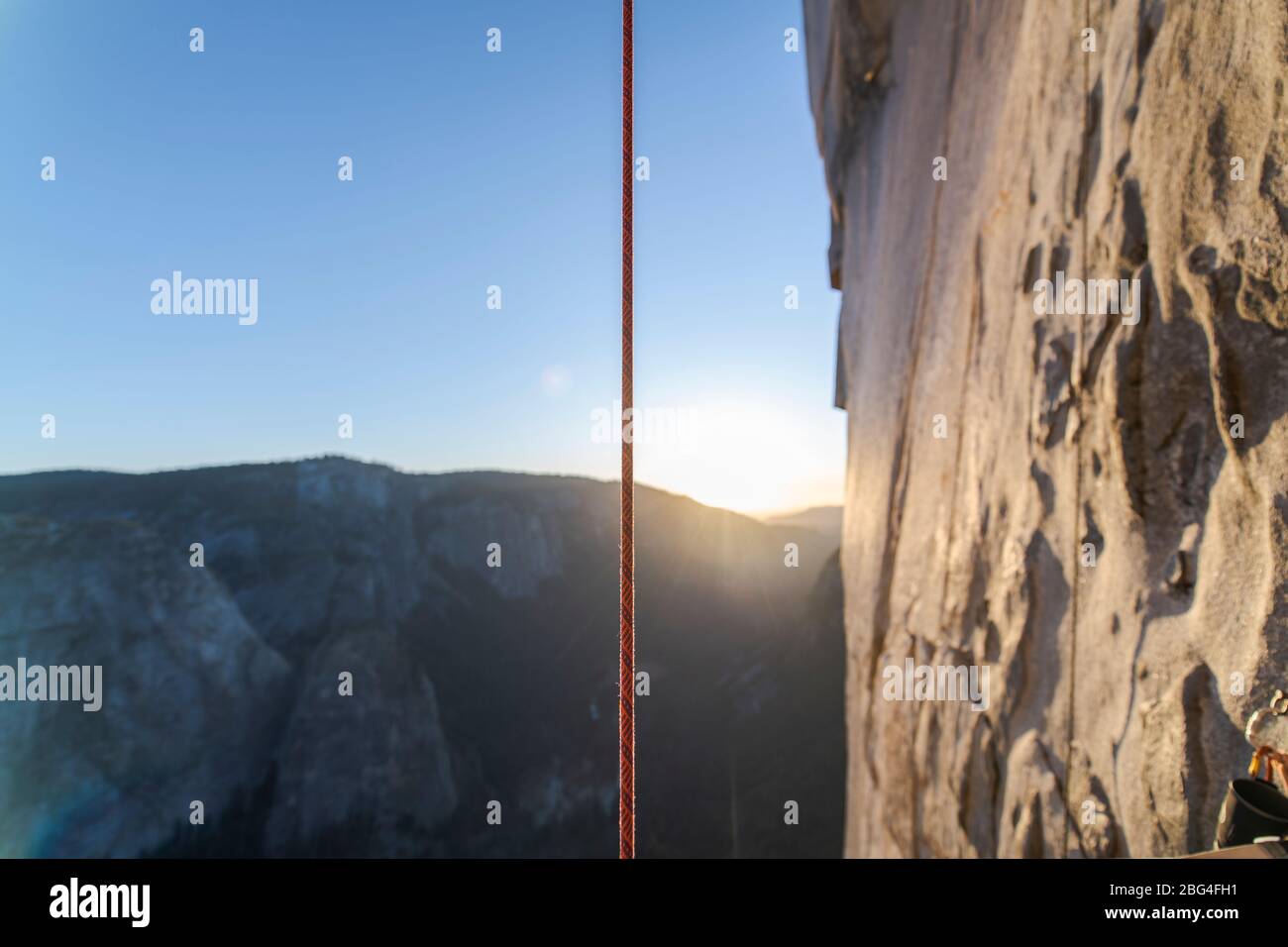 Corde grimpante suspendue verticalement à côté d'El Capitan au coucher du soleil Banque D'Images