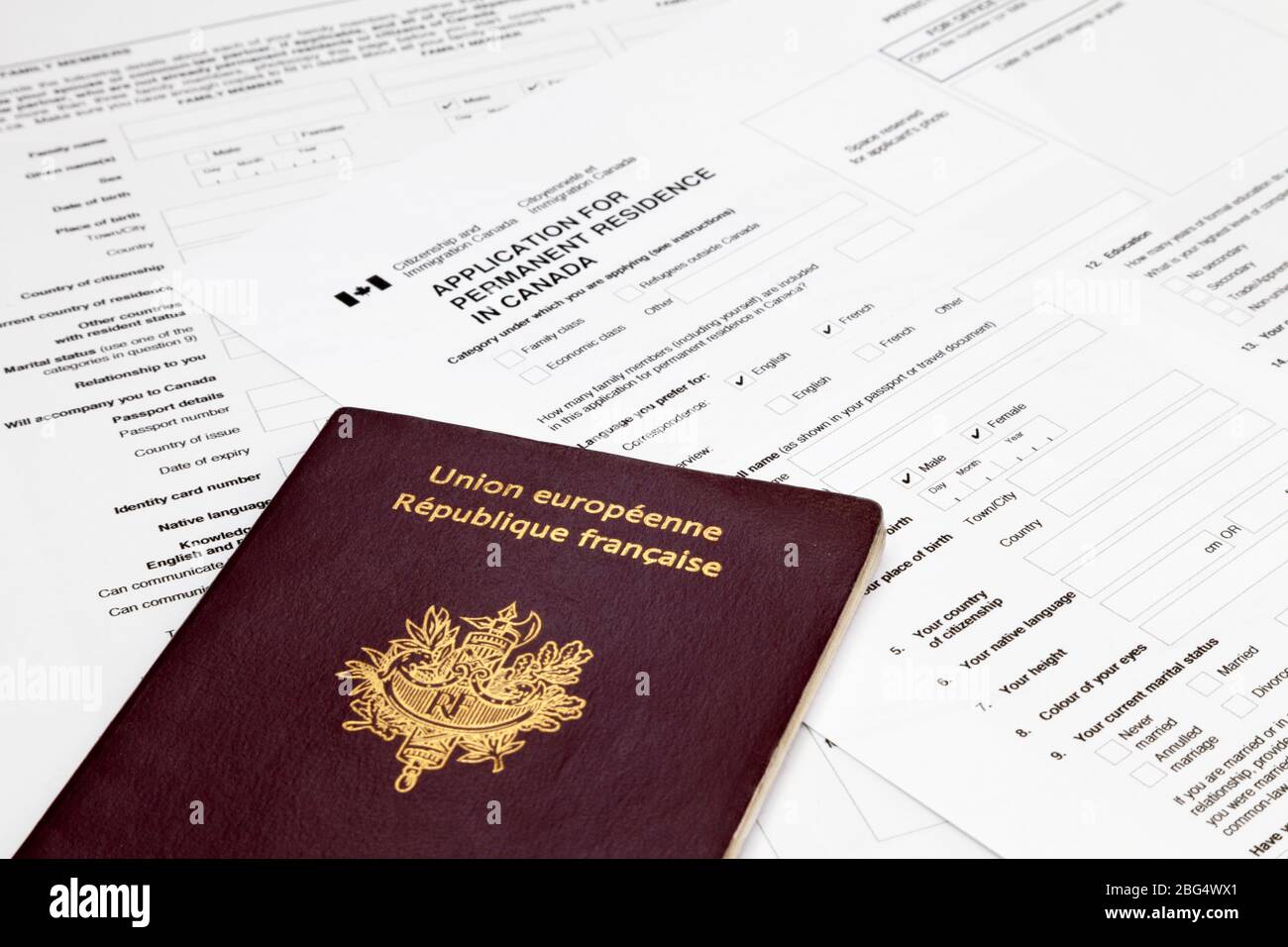 Passeport français en haut d'un formulaire de demande canadien pour obtenir  un visa de résidence permanente Photo Stock - Alamy