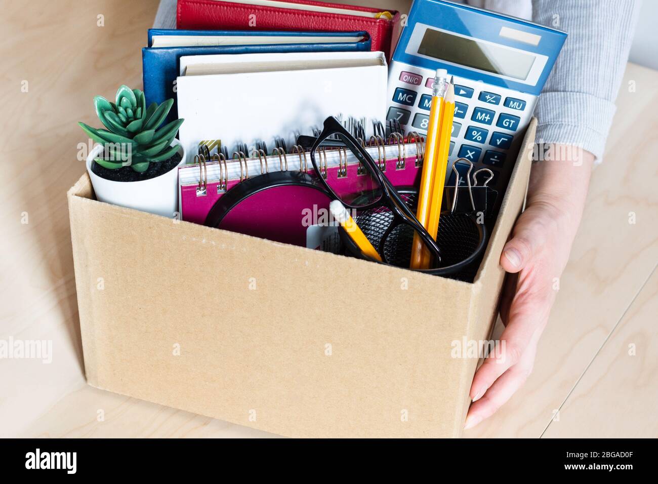 Femme d'affaires tenant une boîte en carton avec des effets personnels de la société. Concept de licenciement ou de démission. Faillite de l'entreprise et crise économique. Banque D'Images