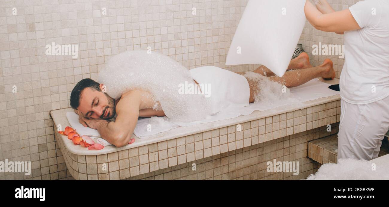 Un turc qui propose un massage à la mousse dans un bain turc. Hammam lave la peau des hommes. Massage en mousse Banque D'Images