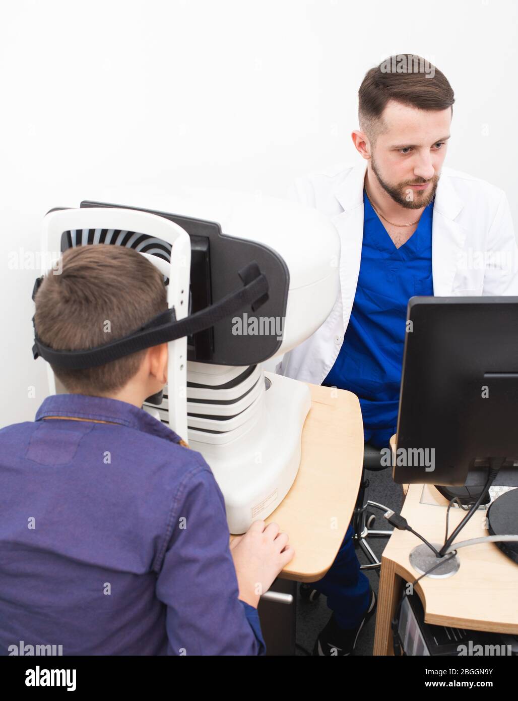 le médecin examine la cornée d'un garçon à l'aide d'un appareil ophtalmique spécial. Traitement du glaucome Banque D'Images