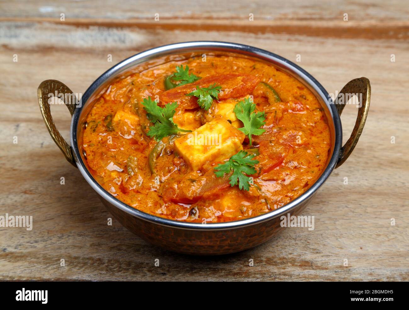 La nourriture indienne ou indien Curry dans un cuivre laiton bol de service. Banque D'Images
