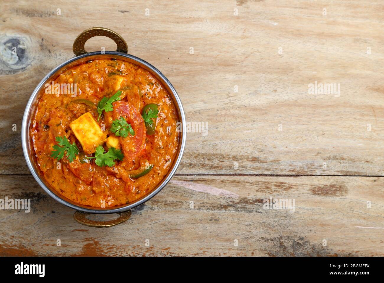 La nourriture indienne ou indien Curry dans un cuivre laiton bol de service. Banque D'Images