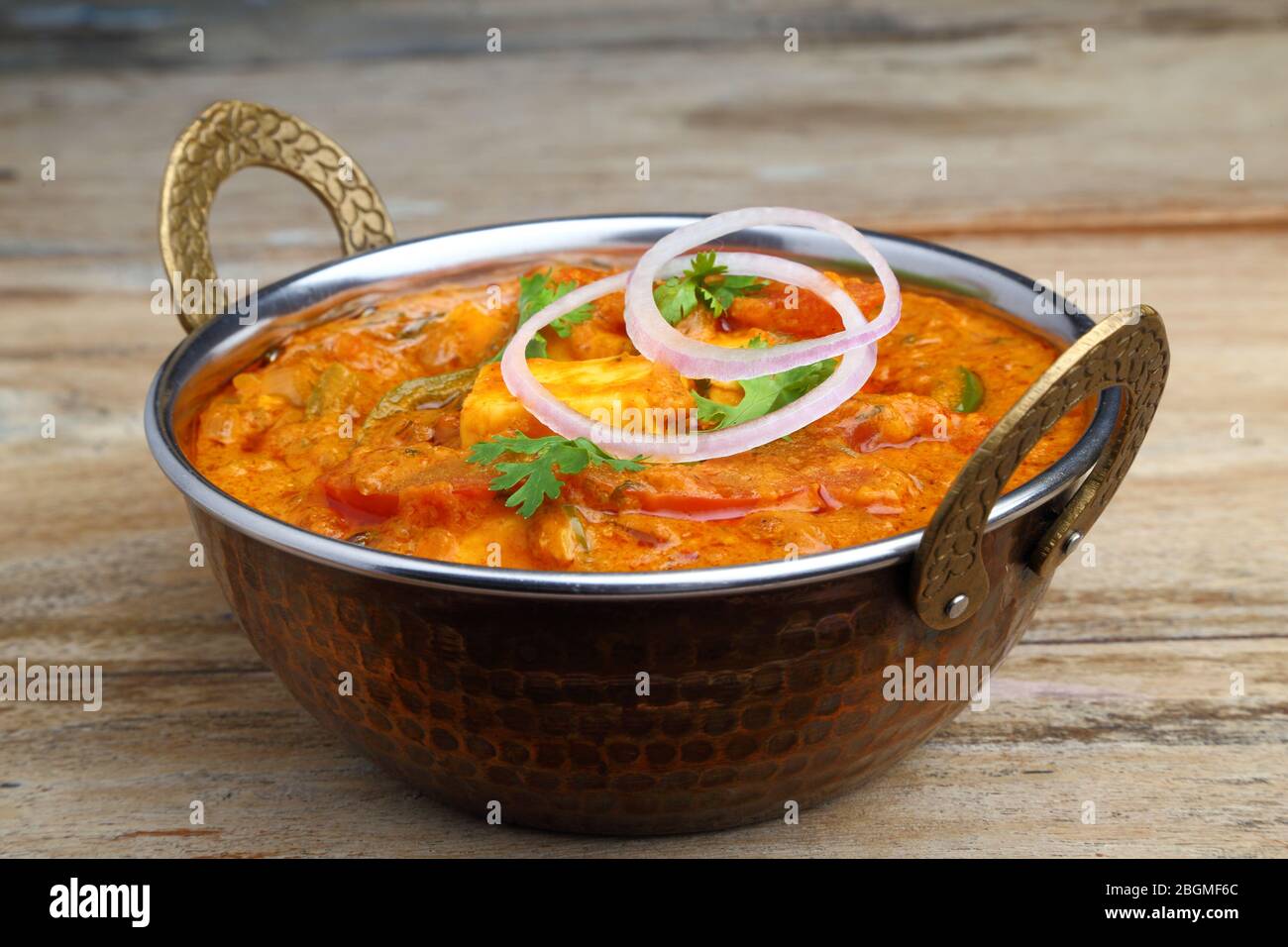 La nourriture indienne ou indien Curry dans un cuivre laiton bol de service. Banque D'Images