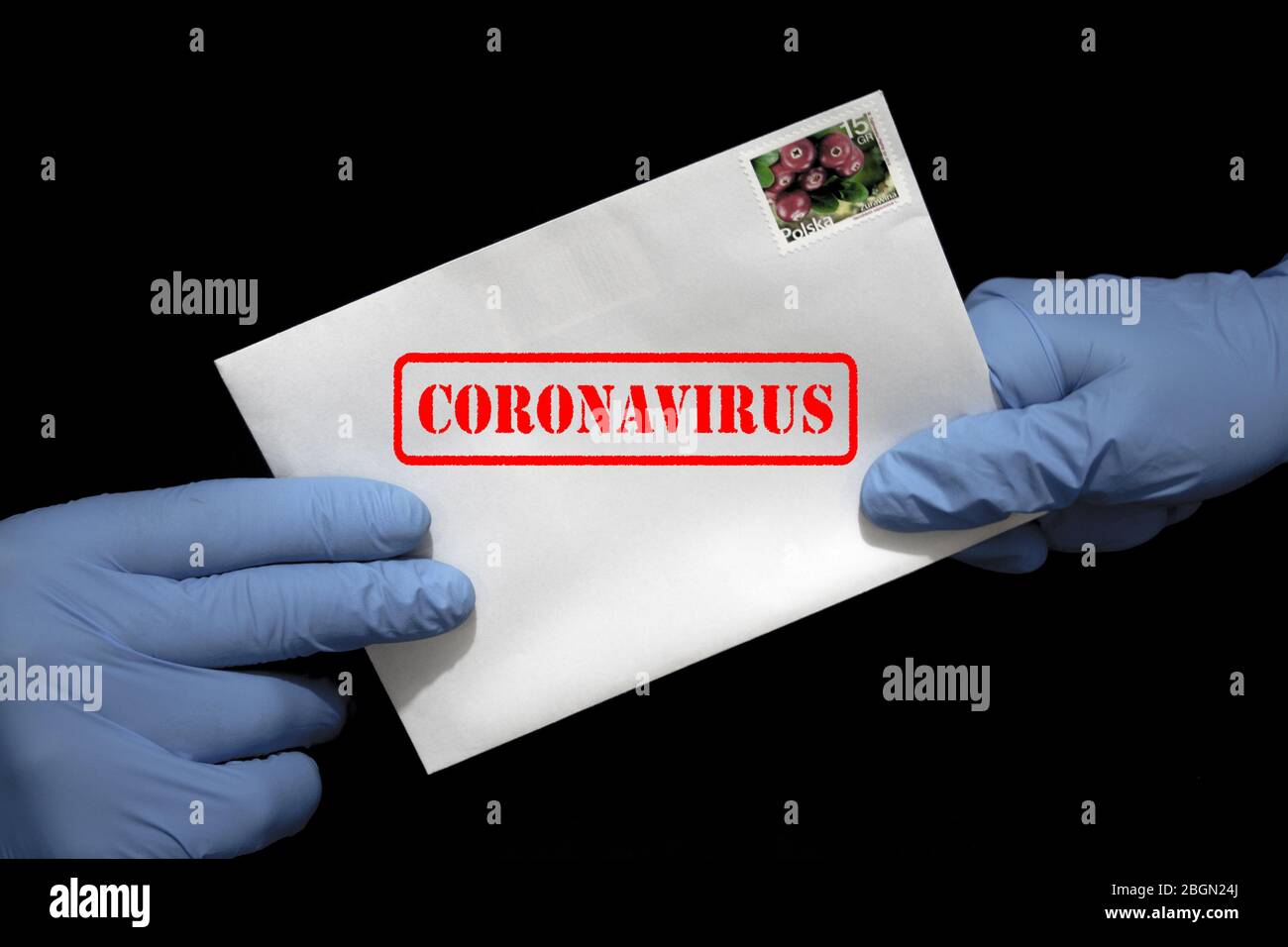 Une main humaine dans des gants de protection contenant une lettre qui peut contenir le virus COVID-19. Les postes peuvent propager le coronavirus. Banque D'Images