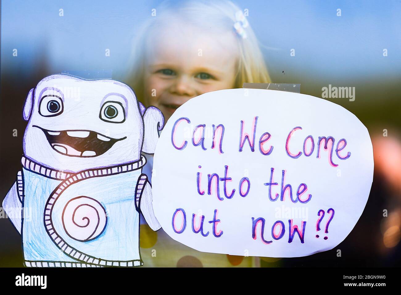 Droitwich, Worcestershire, Royaume-Uni. 22 avril 2020. Orla KEight, 2, apparaît à sa fenêtre dans sa maison à Droitwich Spa avec les affiches demandant si elles peuvent entrer dans le dehors maintenant. [Note: Autorisation parentale accordée] crédit: Peter Lopeman/Alay Live News Banque D'Images