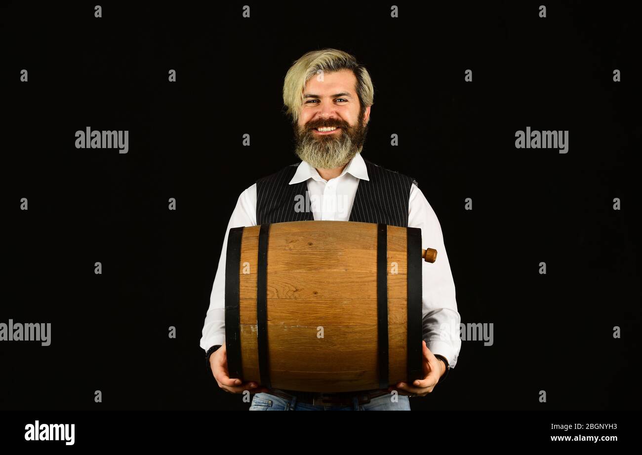 Concept de cave de vinification. La production de la tradition de la famille du vin. Barbu homme hipster barbu barrel en bois pour vin noir fond. Vin maison. Produit de fermentation. Conseils pour acheter des vins anciens et rares. Vin naturel. Banque D'Images