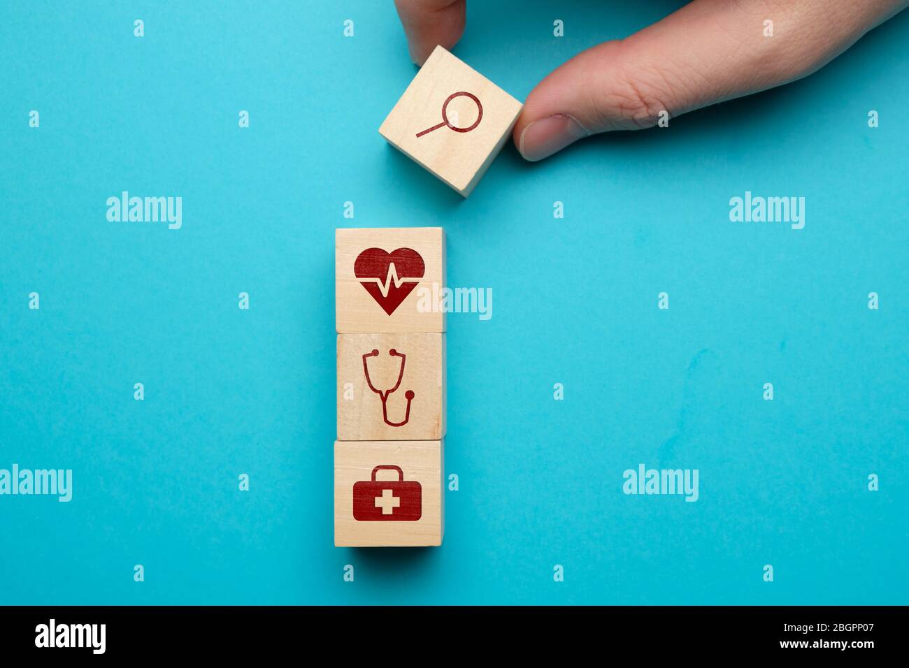 Concept de recherche de soins médicaux avec icônes sur des blocs de bois. Gros plan. Banque D'Images