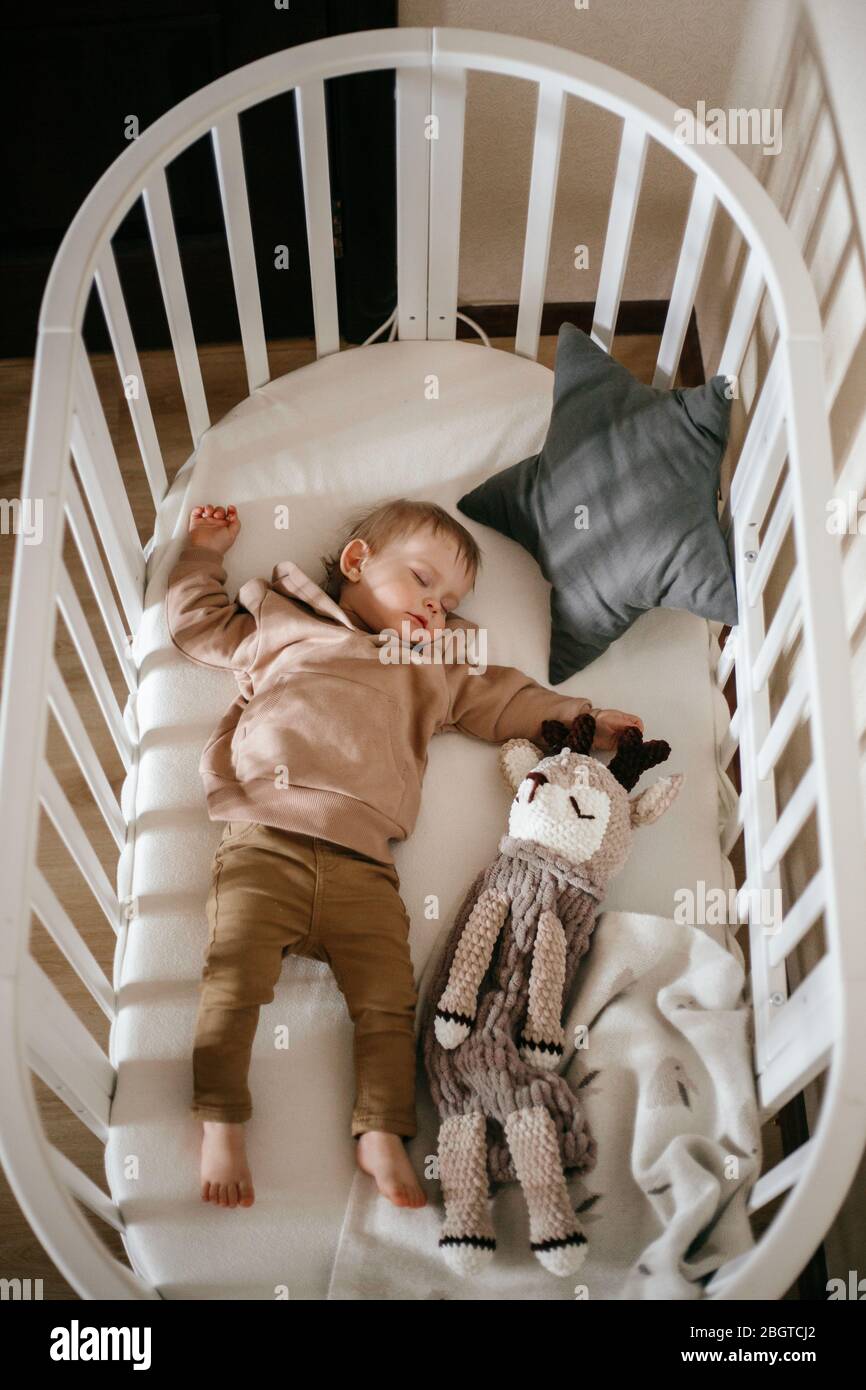 Un Bebe Mignon De 1 An Est Allonge Sur Un Lit Bebe Tout En Dormant Avec Des Fenetres De Lumiere Sur Son Visage Concept De Sommeil De Jour Photo Stock Alamy