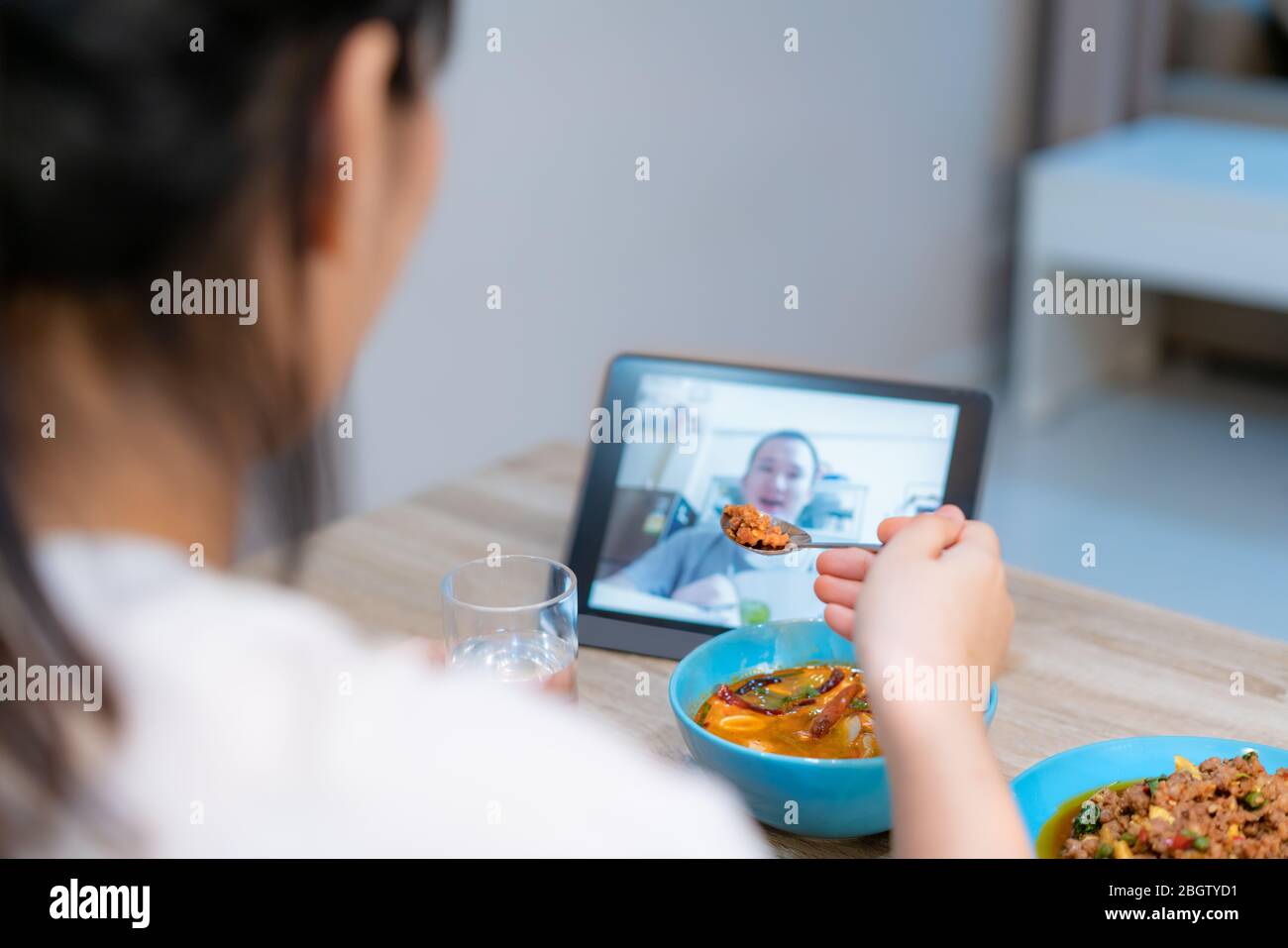 Femme asiatique virtuel Happy Hour dîner de réunion et manger de la nourriture en ligne avec son petit ami en visioconférence avec tablette numérique pour un en ligne Banque D'Images