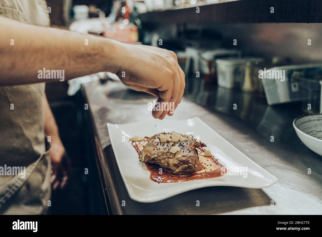 Chef s'occupant de plats sur les assiettes avant de servir au restaurant Banque D'Images