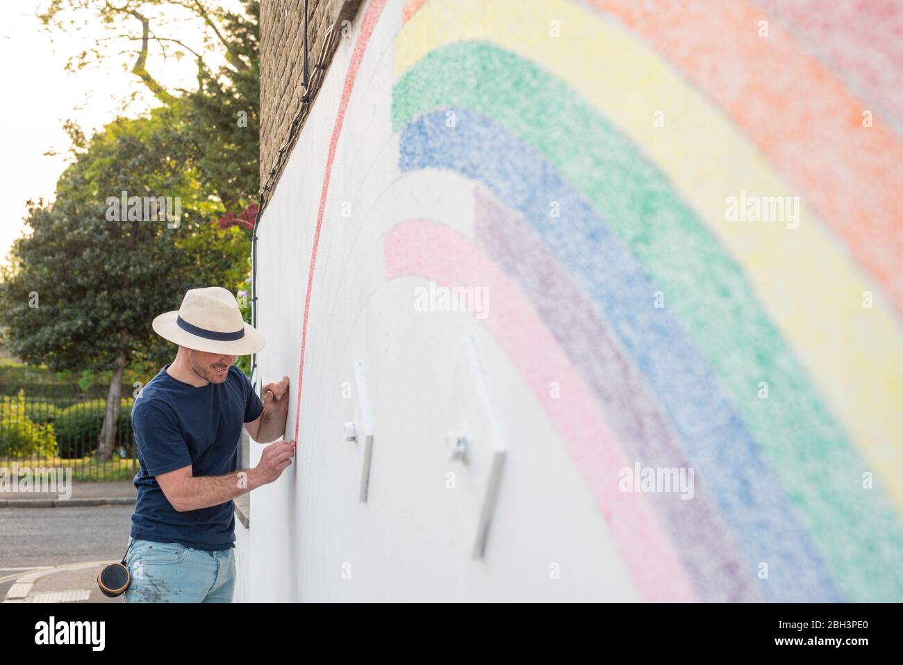 Camberwell, Londres, Royaume-Uni. 23 avril 2020. Louis Young dessine une murale d'un arc-en-ciel sur le mur de sa maison pour vous remercier du NHS pour avoir pris soin de son père. Son père est sorti de l'hôpital aujourd'hui après des semaines d'une maladie pulminaire mais non covid-19. Crédit: Tom Leighton/Alay Live News Banque D'Images