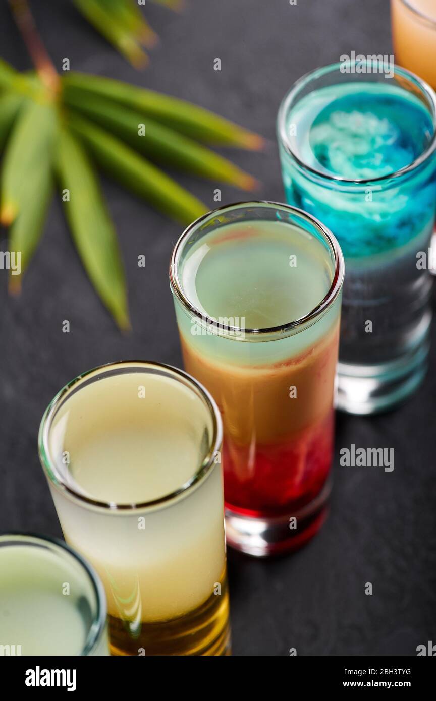 Une rangée de cocktails à prendre sur le plateau noir en ardoise. Ensemble de cocktails alcoolisés. Bar tropical Banque D'Images