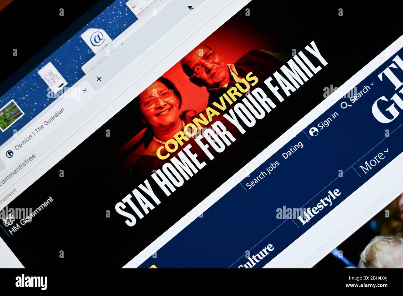 Publicité d'information sur le magazine britannique Government Covid placée dans un journal en ligne. Légende 'Coronavirus, restez à la maison pour votre famille'. Banque D'Images