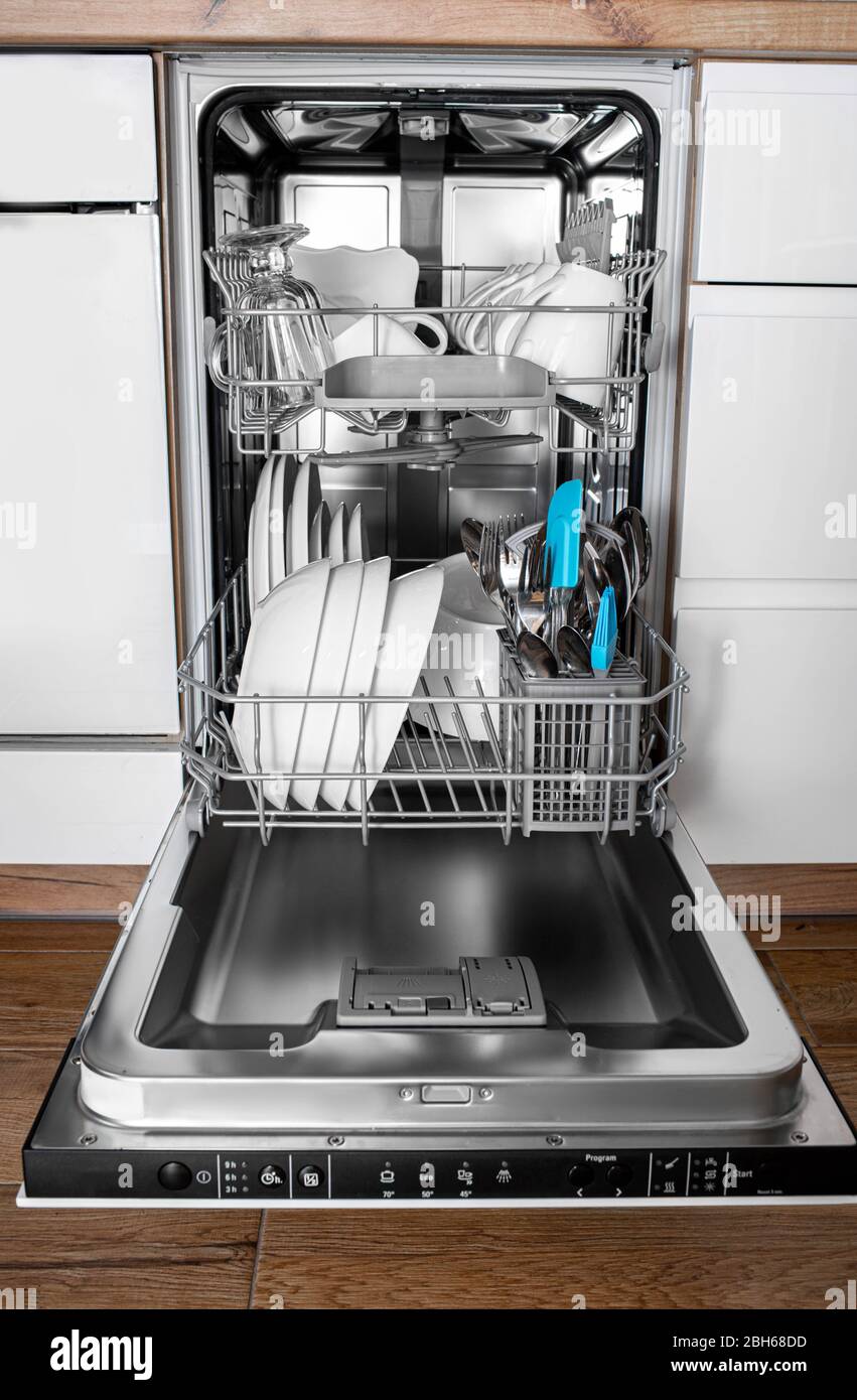 Lave-vaisselle intégré dans une cuisine moderne avec des plats propres après le lavage. Vue avant Banque D'Images