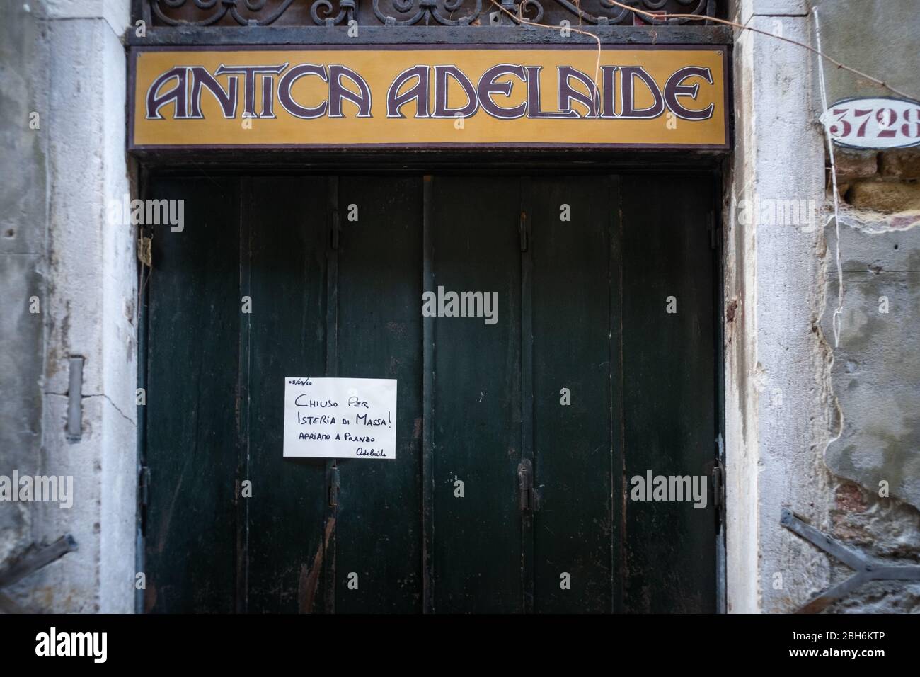 VENISE, ITALIE - AVRIL 2020: Un restaurant fermé avec un panneau avec l'écrit 'fermé pour hystérie de masse' pendant le verrouillage national pour Covid-19 pand Banque D'Images