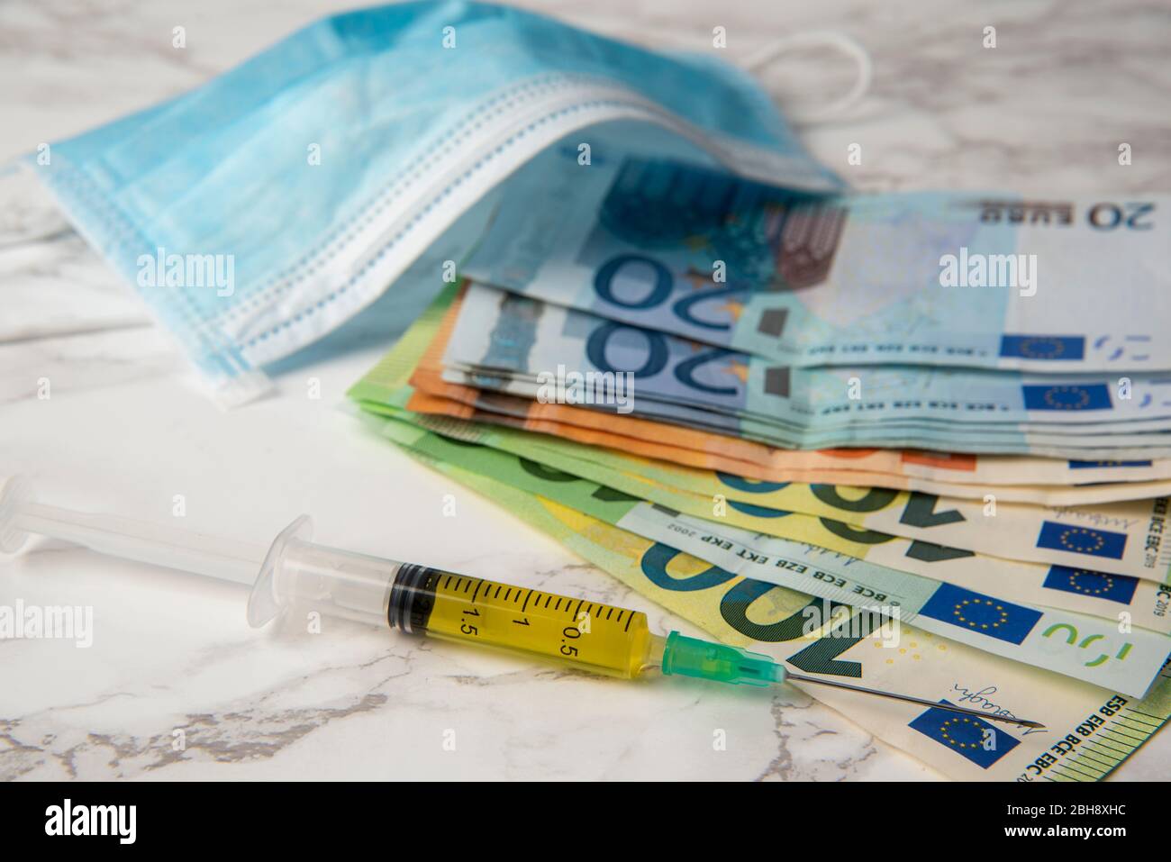 seringue et billets en euros avec masque médical corona économique Banque D'Images