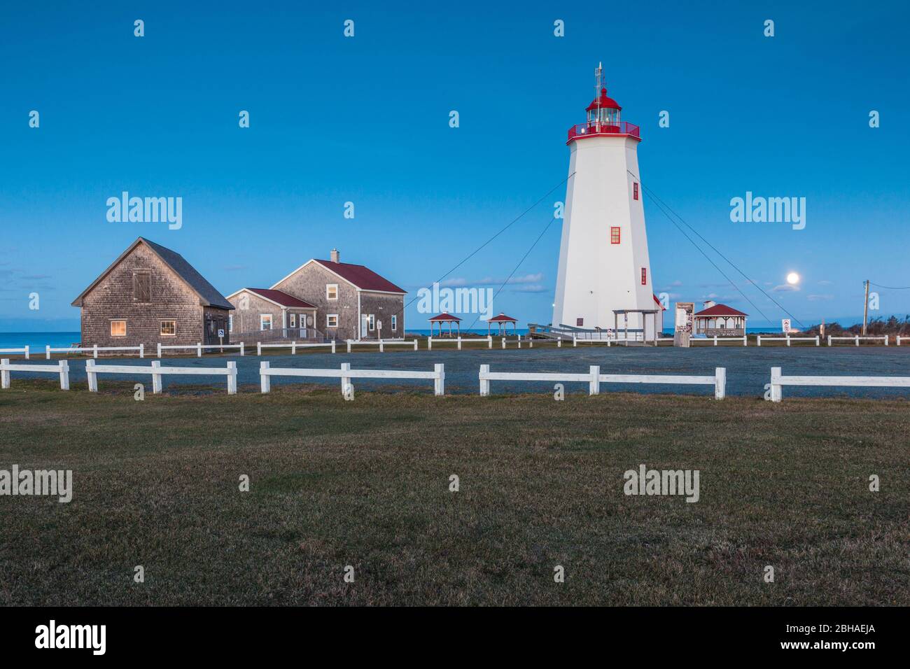 Canada, Nouveau-Brunswick, de la Péninsule acadienne, l'Île Miscou, phare de Miscou, dusk avec pleine lune Banque D'Images Canada, Nouveau-Brunswick, de la Péninsule acadienne, l'Île Miscou, phare de Miscou, dusk avec pleine lune Banque D'Images