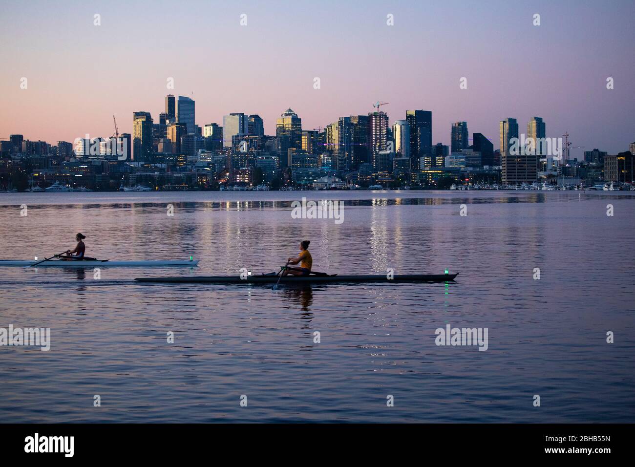 Deux personnes kayak au crépuscule avec horizon de la ville en arrière-plan, Seattle, Washington, USA Banque D'Images