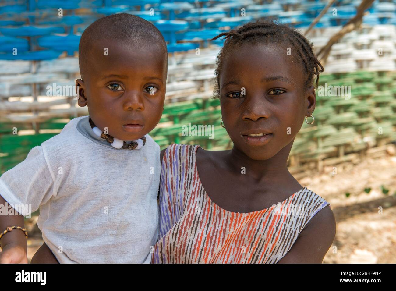 Portrait d'une fille portant un frère plus jeune à la forêt de Makasutu Cutlure en Gambie. Banque D'Images