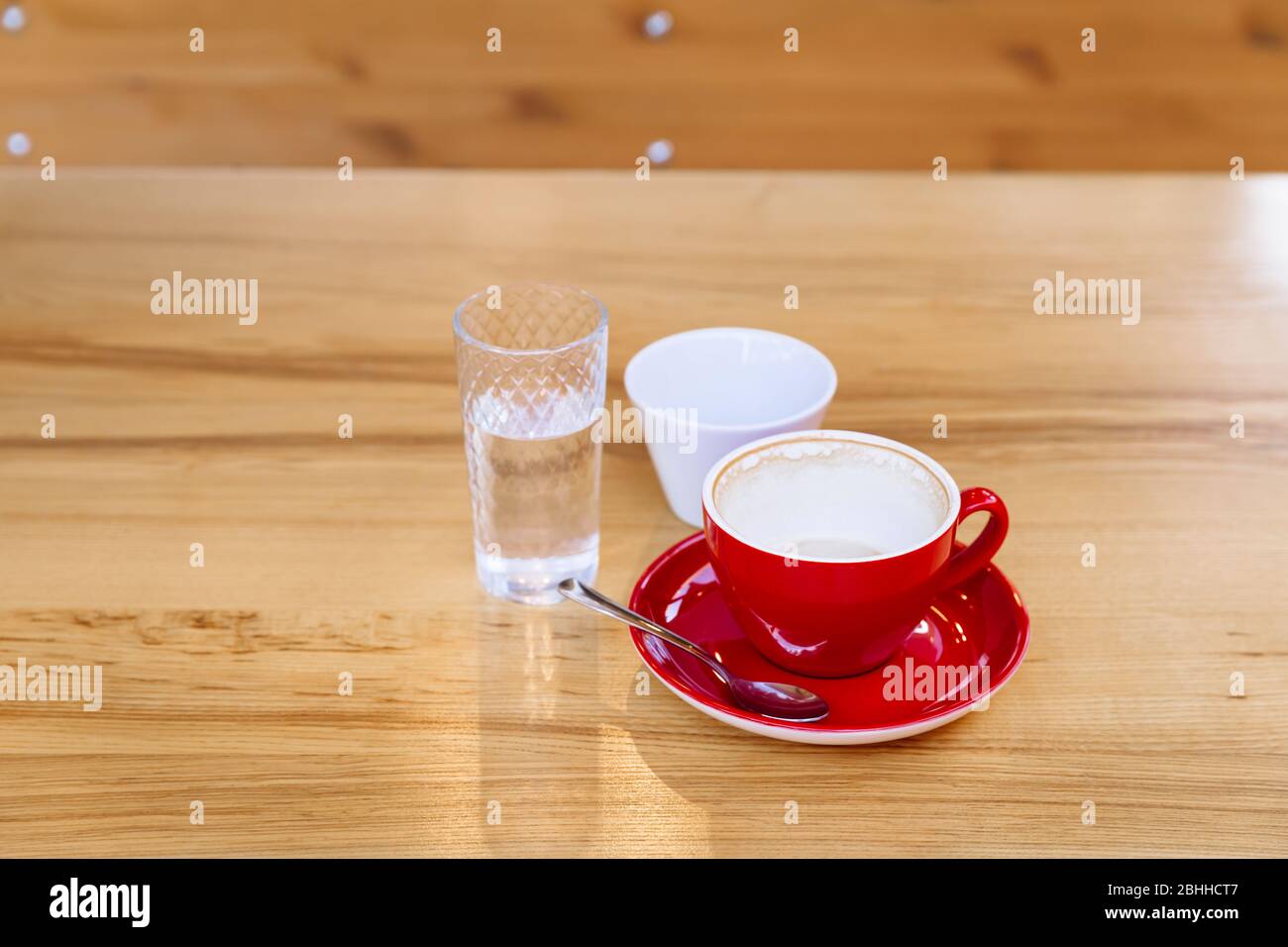 Tasses à café sales, cappuccino et un verre d'eau sur une table en bois. Pause café. Régalez-vous de goût et d'arôme. Banque D'Images