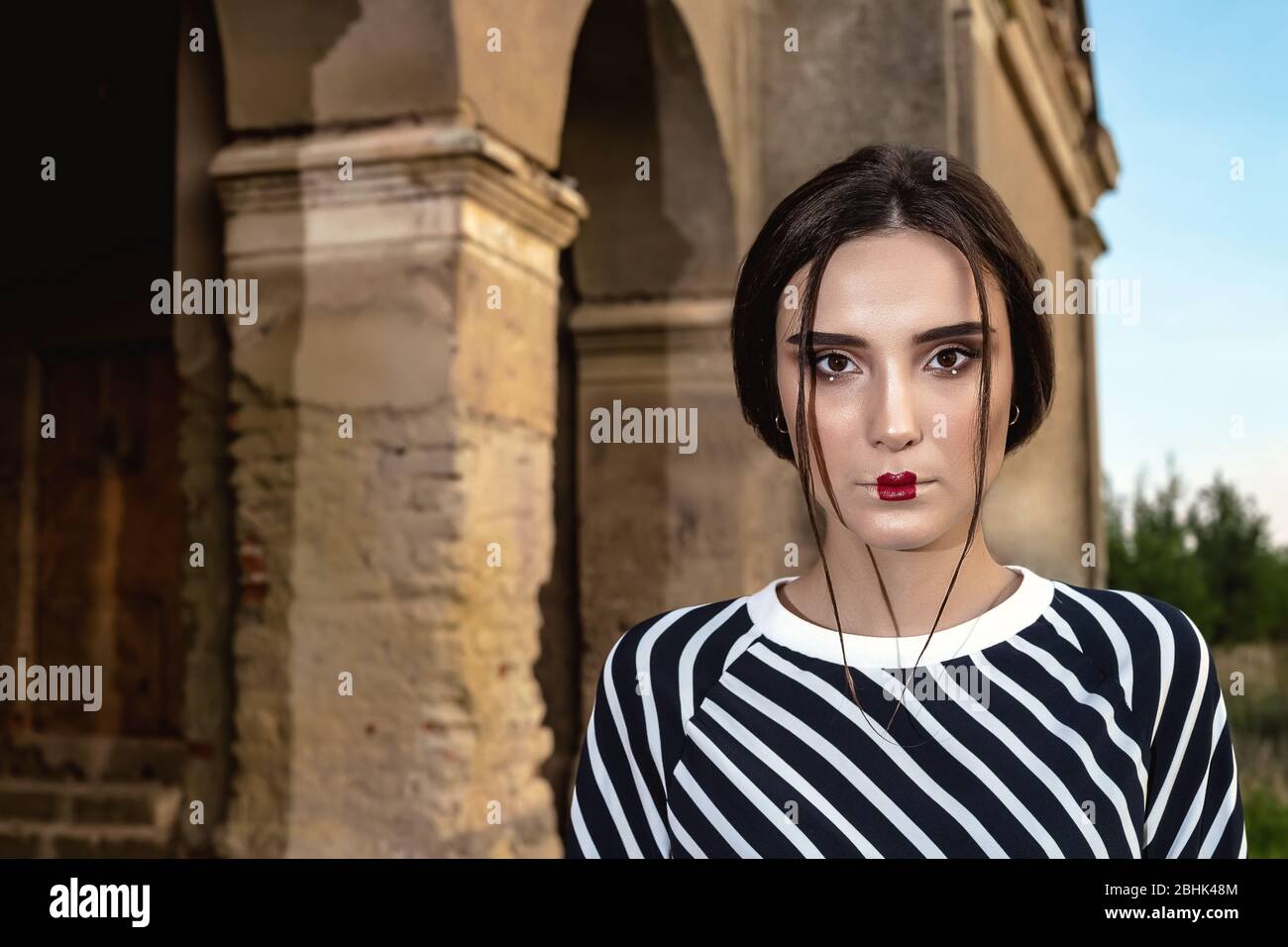 Piscine fashion portrait de deux jeunes et belles femmes portant des vêtements à la mode qui posent sur la rue dans le contexte d'un vieux abandonné buil Banque D'Images