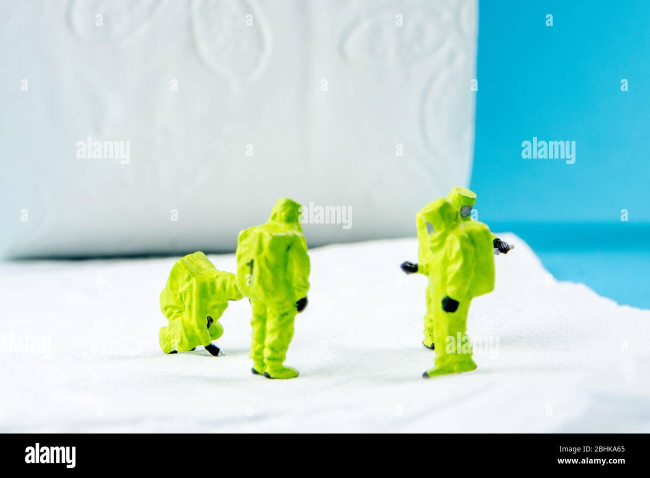 une équipe de figurines miniatures vérifiant une propreté du papier toilette, très important pour faire une desinfection de la toilette et d'autres endroits peut-être sale Banque D'Images