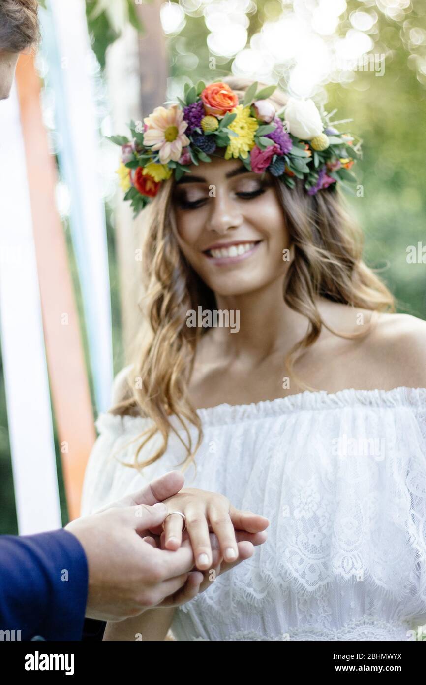 Groom mis sur un anneau au doigt de la mariée pendant la cérémonie de mariage Banque D'Images