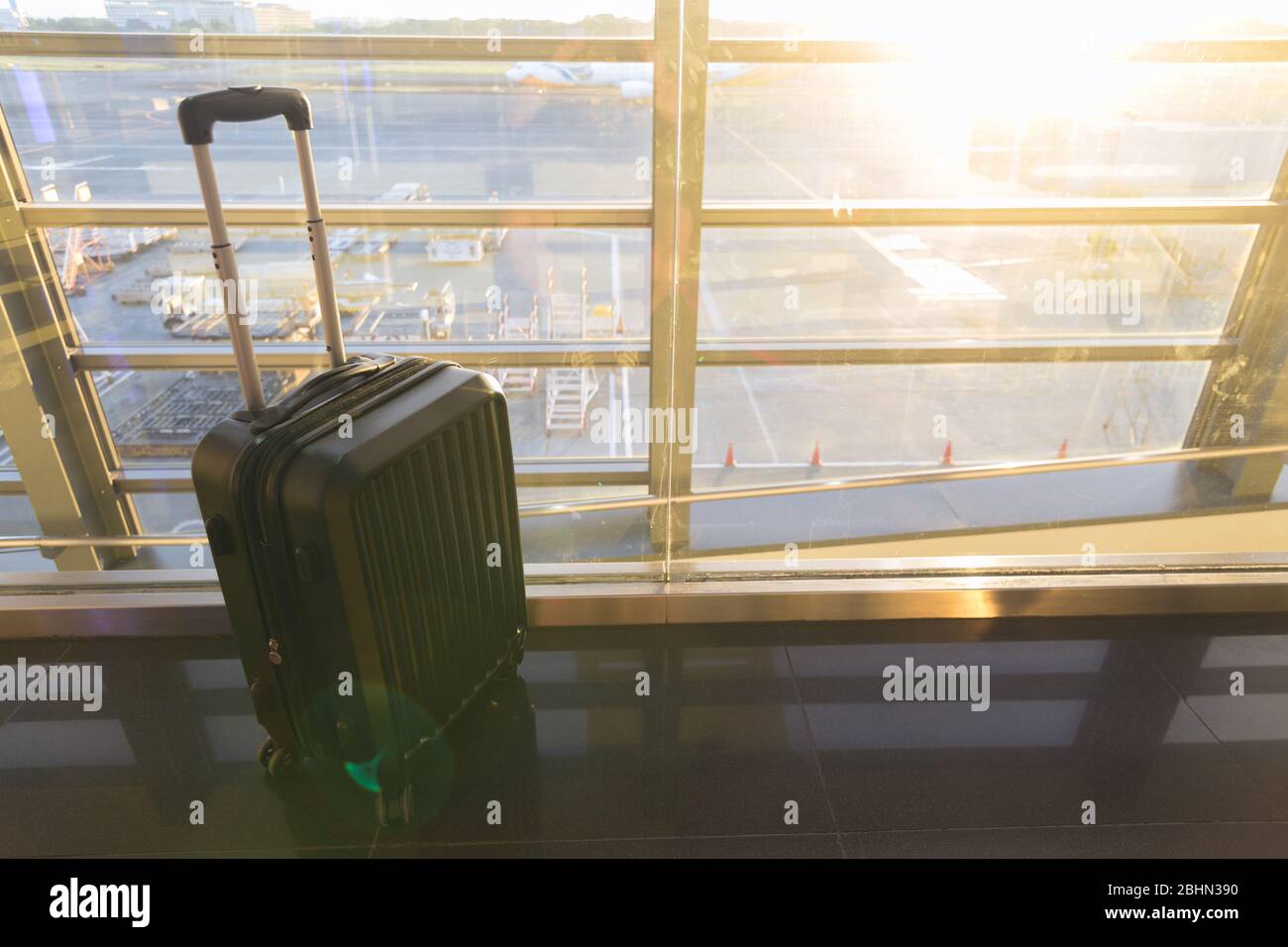 Gros plan d'une grande valise à bagages près de la fenêtre de l'aéroport. Concept de déplacement Banque D'Images