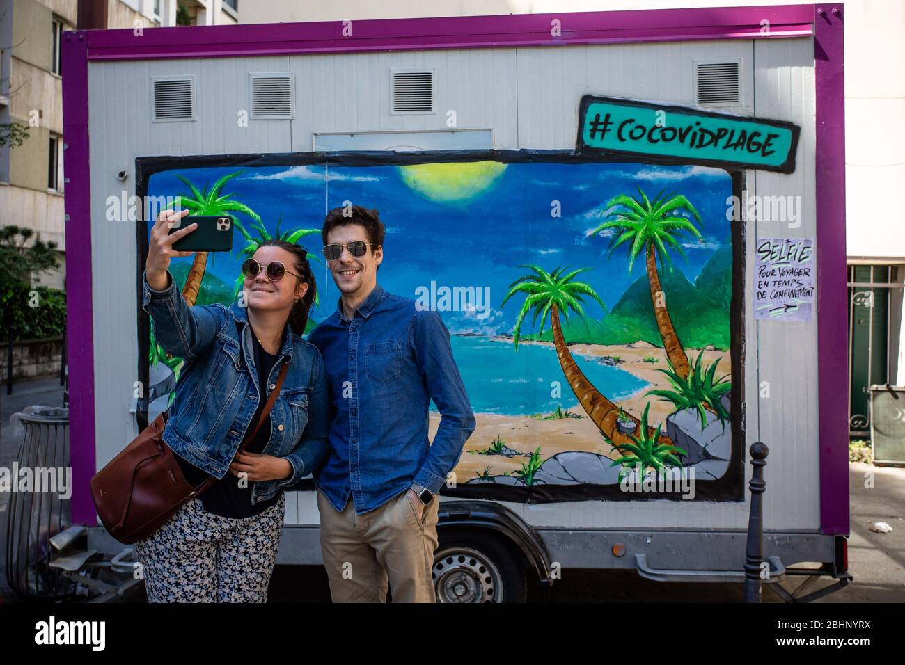 Paris. 26 avril 2020. Les gens prennent selfie devant une fresque installée par le peintre français et l'artiste graffiti Katre dans une rue à Paris, France, le 26 avril 2020, pendant le maintien pour arrêter la propagation de COVID-19. Crédit: Aurelien Morissard/Xinhua/Alay Live News Banque D'Images