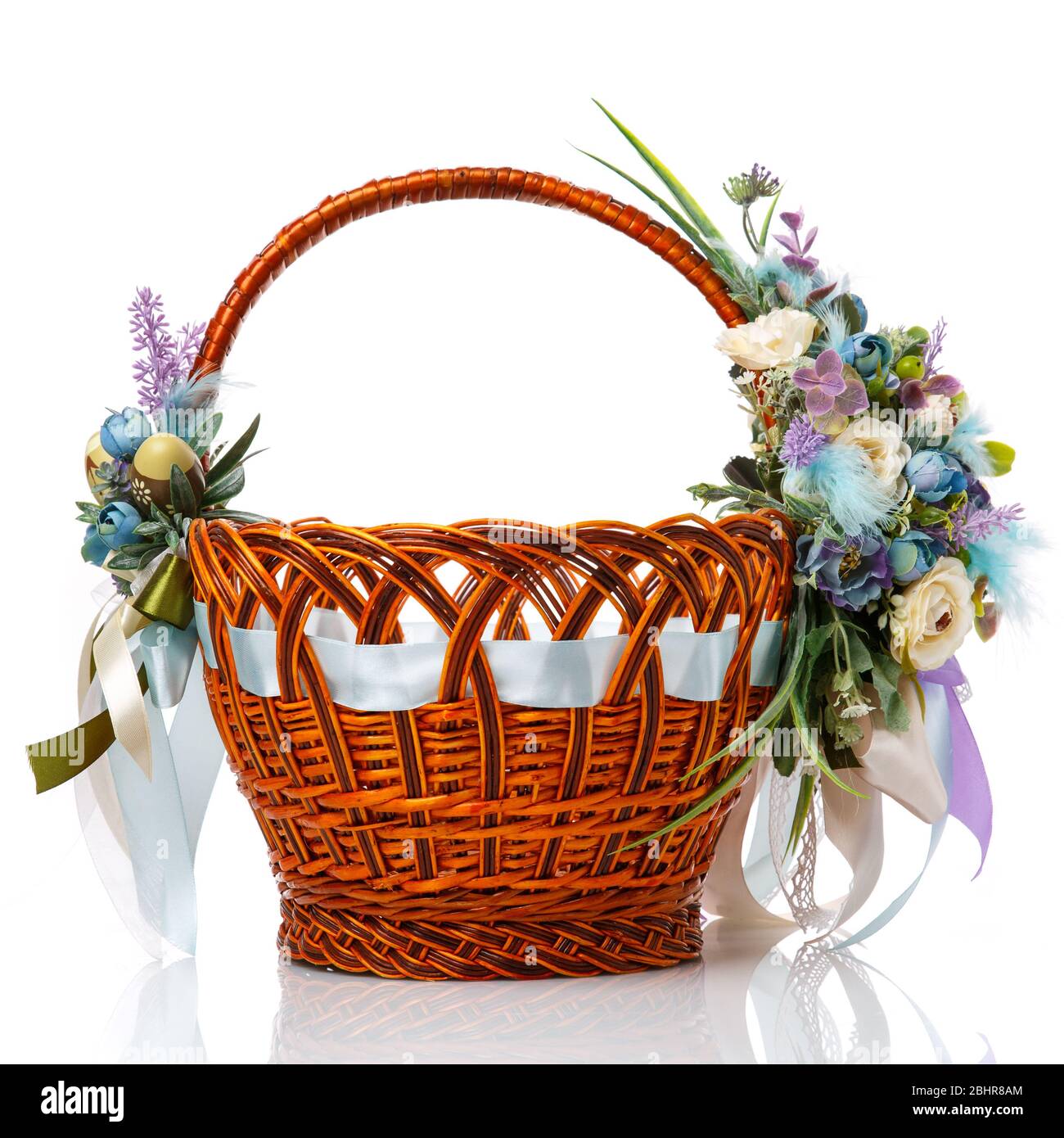 Magnifique panier décoratif avec fleurs pour la fête de Pâques sur fond blanc Banque D'Images