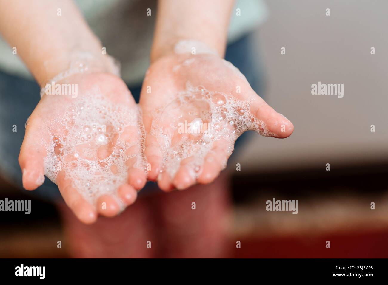 Mains pour enfants en mousse savonneuse. Le concept de lavage des mains, d'hygiène. Concept de coronavirus. Protection contre la pandémie. Prévention Banque D'Images