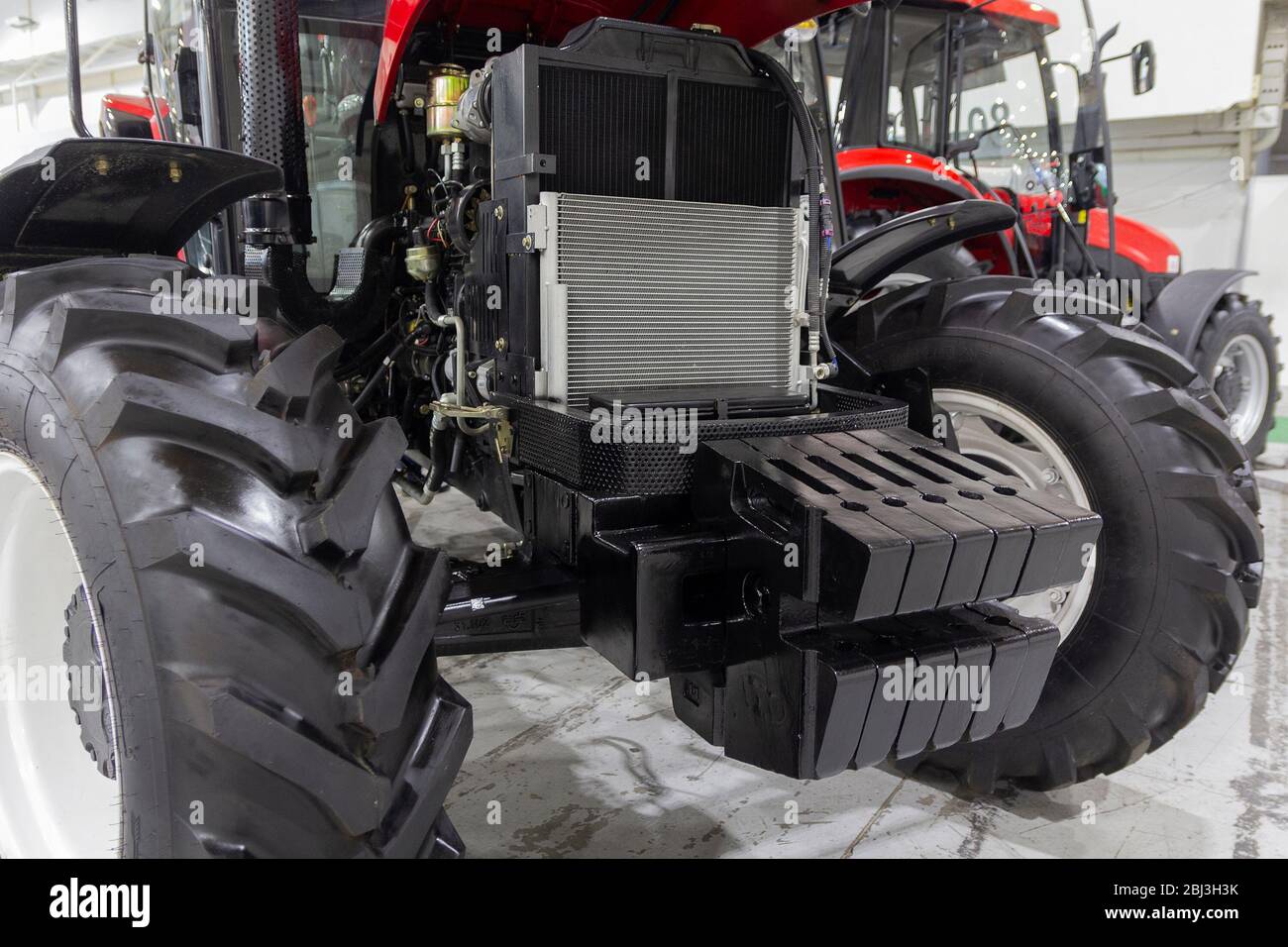 Tracteur avec capot ouvert dans le hall d'exposition. Industrie Banque D'Images