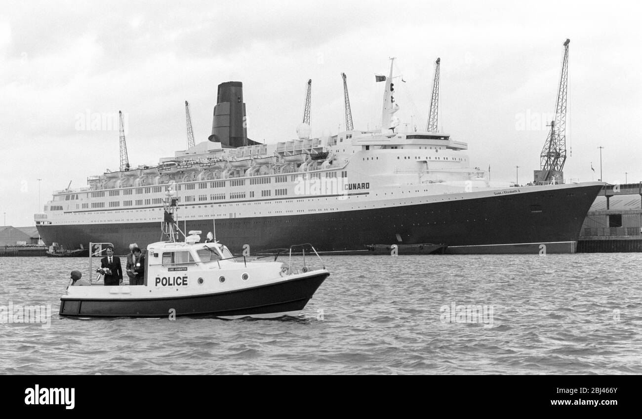 Photo vintage de la reine Elizabeth 2 de RMS amarrée à Port de Southampton avec le lancement maritime de la police du Hampshire Lord Ashburton au premier plan. Banque D'Images