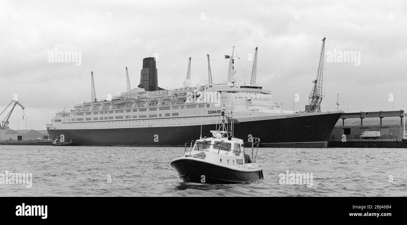 Photo vintage de la reine Elizabeth 2 de RMS amarrée à Port de Southampton avec le lancement maritime de la police du Hampshire Lord Ashburton au premier plan. Banque D'Images