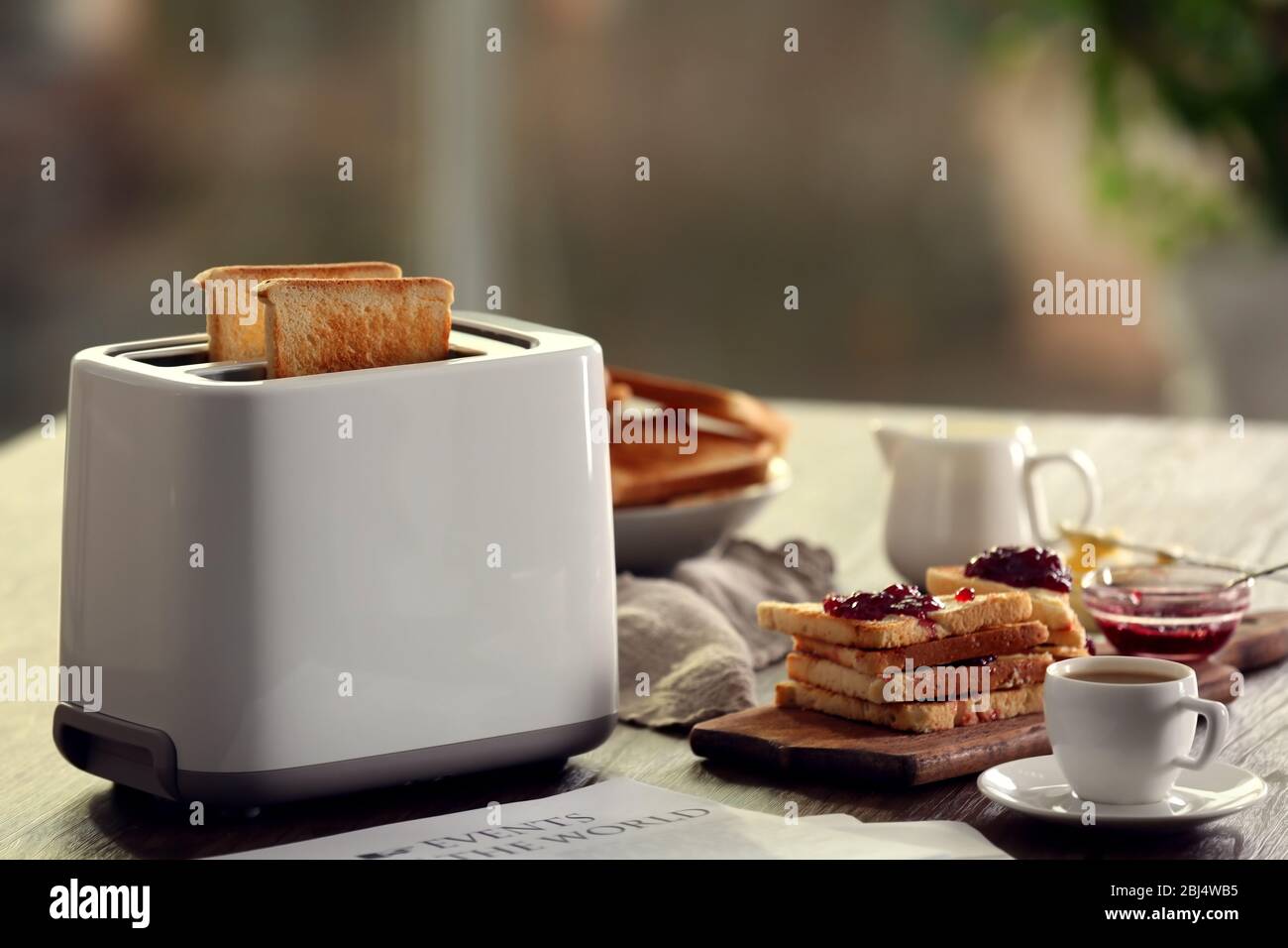 Table pour le petit-déjeuner avec toasts et café, sur fond flou Banque D'Images