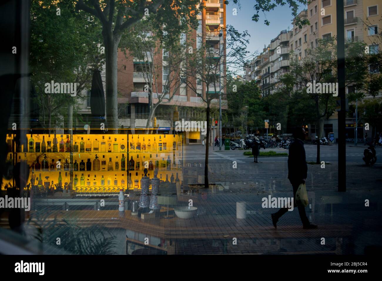28 avril 2020, Barcelone, Catalogne, Espagne - un piéton se reflète dans la fenêtre d'un bar fermé à Barcelone. Le Premier ministre espagnol a annoncé que les mesures de désescalade du verrouillage du coronavirus dureront de six à huit semaines. Credit:Jordi Boixaeu/Alay Live News Banque D'Images