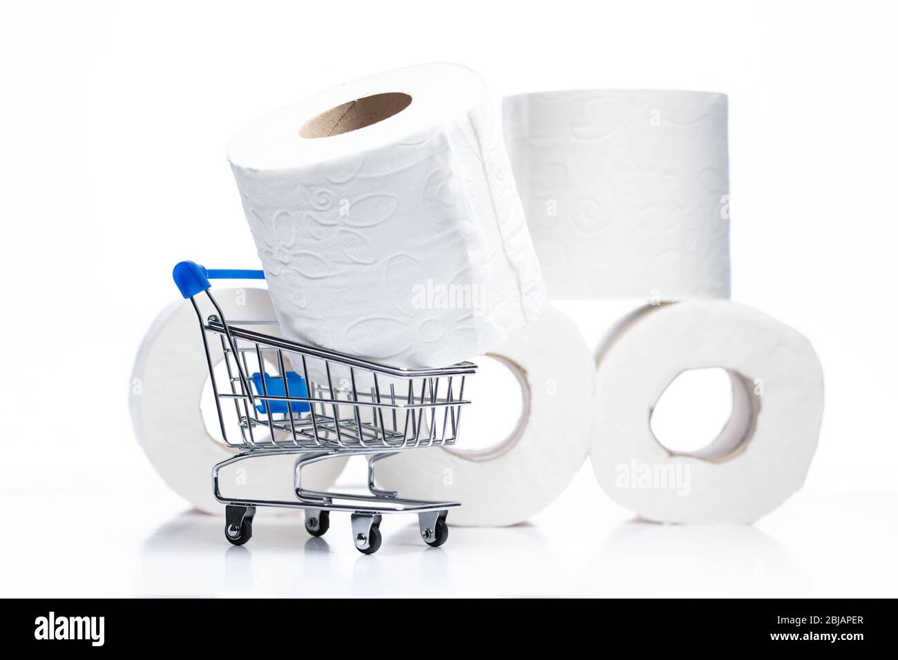 Panier d'épicerie avec toilettes rouleaux de papier derrière. Concept de manque de papier toilette dans les magasins en raison du coronavirus, Covid-19 Banque D'Images